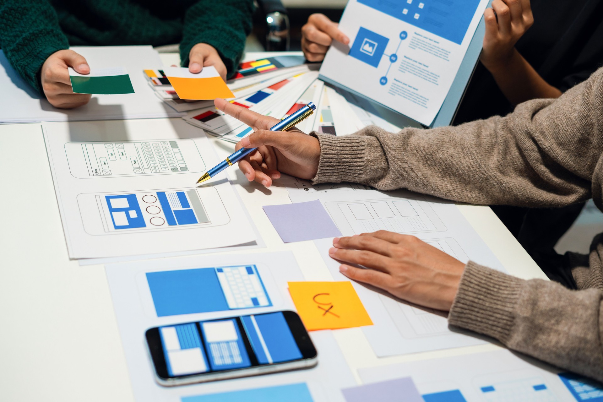 UX developer and ui designer brainstorming about mobile app interface wireframe design with customer breif and color code, User experience concept